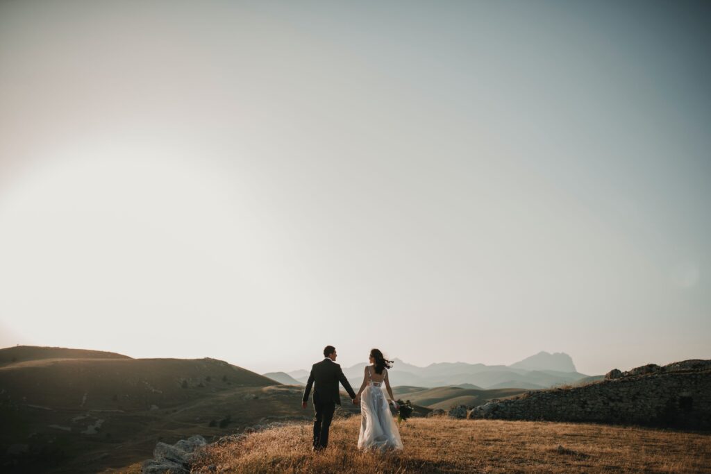 bride and groom silhouettes as they stand on a mountain top. Christian Marriage and why it is special