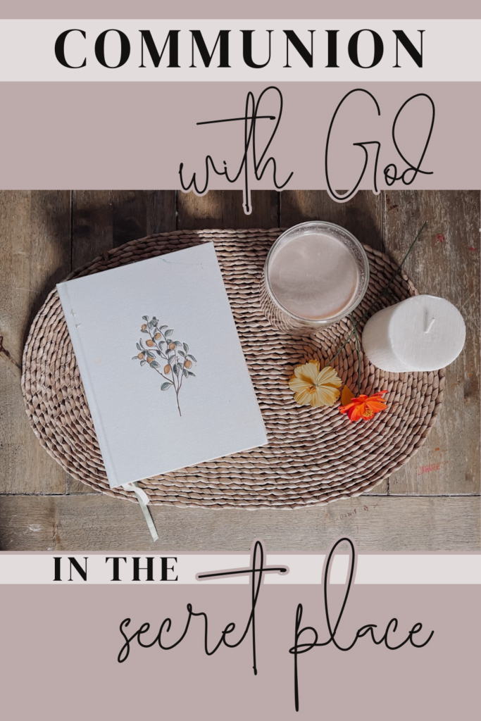 Communion with God in the Secret Place text with a bible, coffee, flowers, and a candle on a rattan placemat on a wooden table